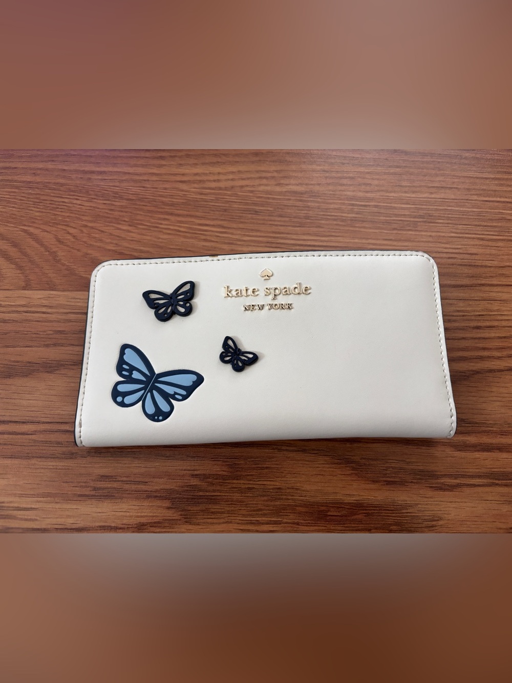 kate spade cream leather slim bifold wallet with blue butterfly accents